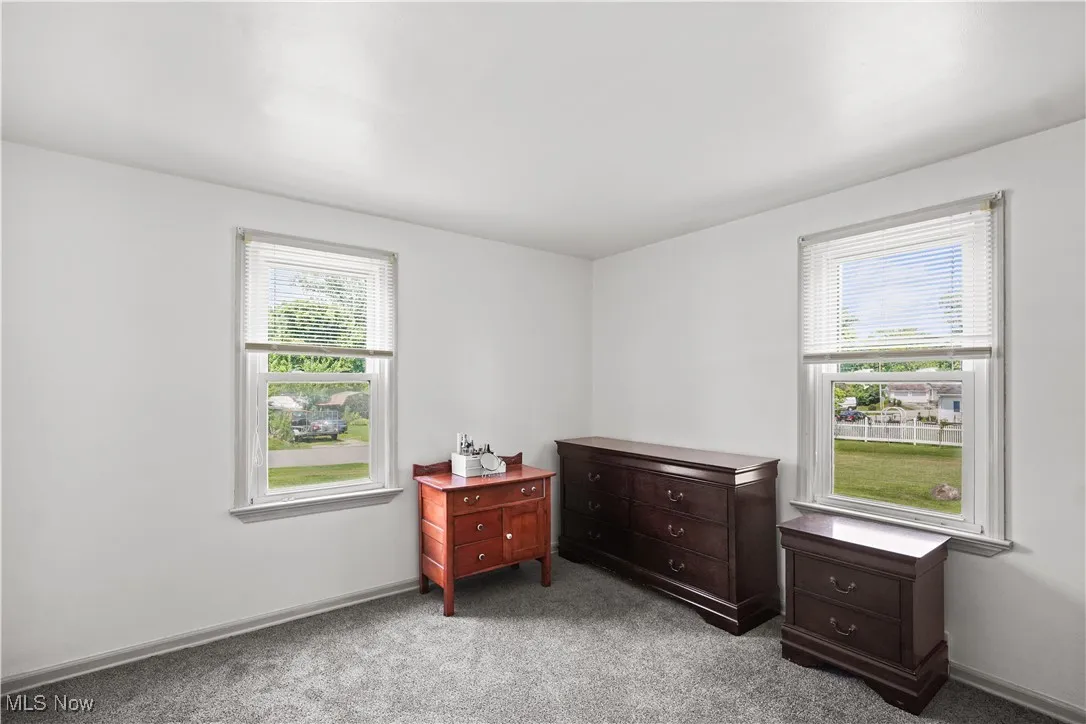 Carpeted bedroom with baseboards
