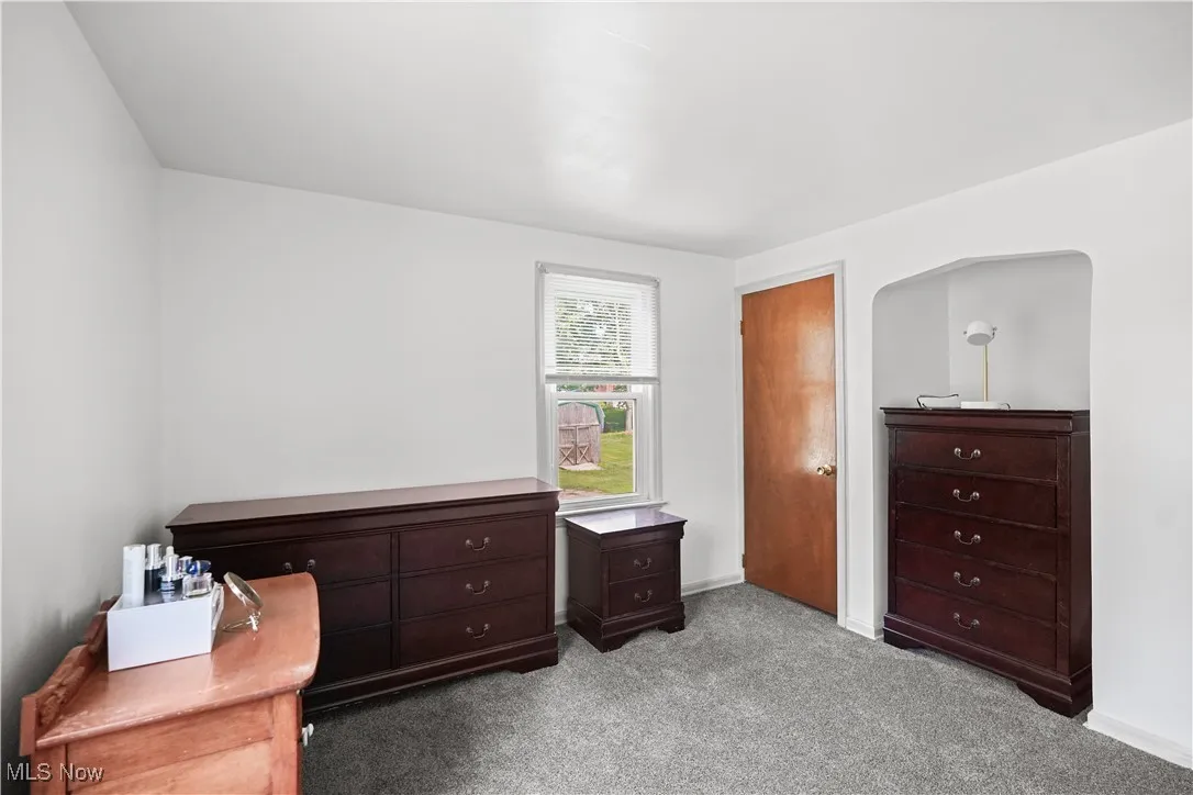 Carpeted bedroom featuring baseboards