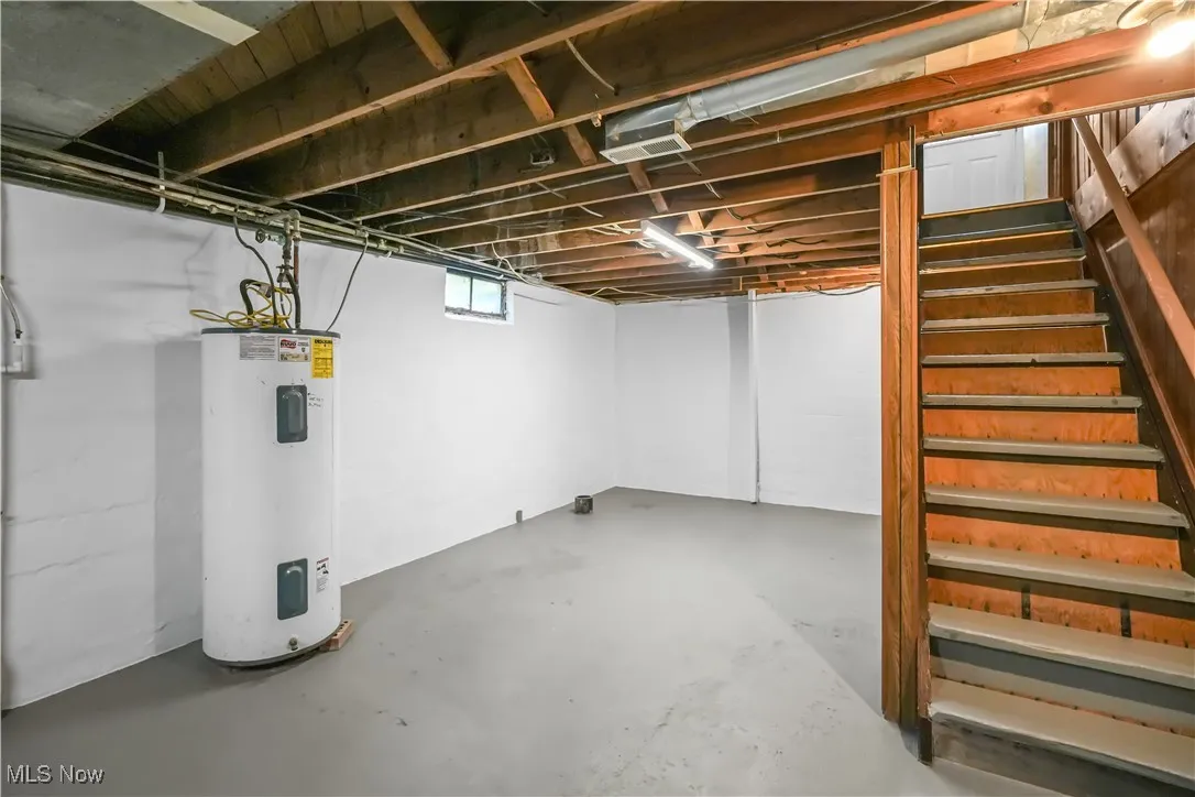 Basement with water heater and stairway