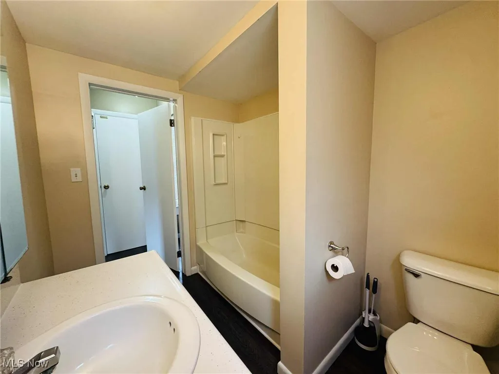 Full bathroom featuring toilet and vanity