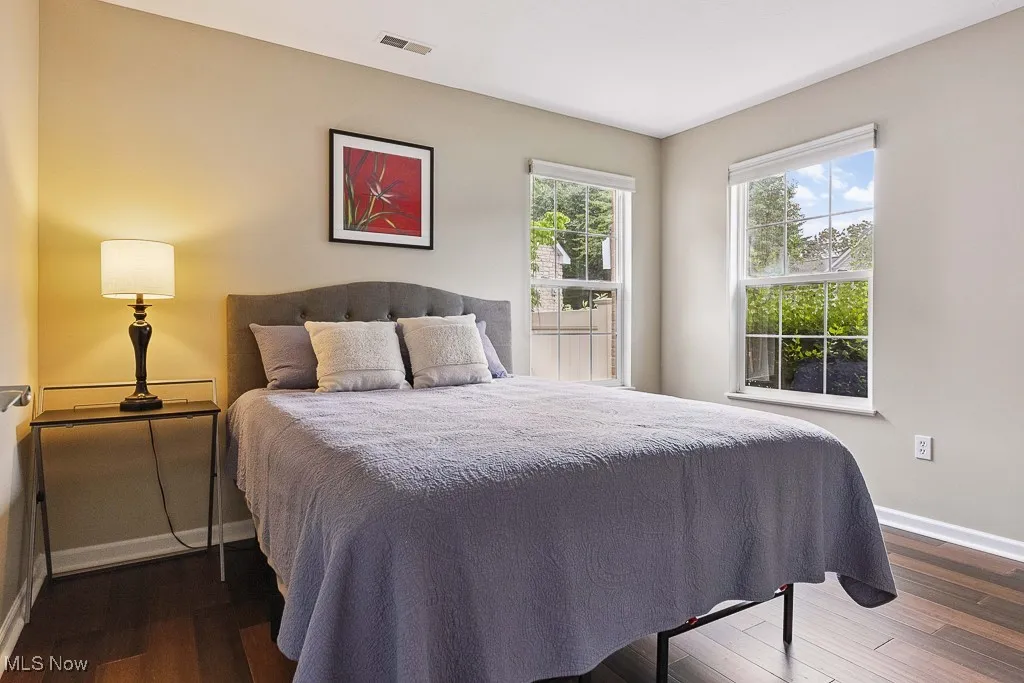 Bedroom featuring baseboards and dark wood-type flooring