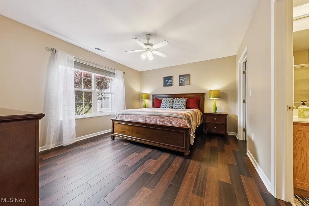 Bedroom featuring dark wood finished floors and a ceiling fan
