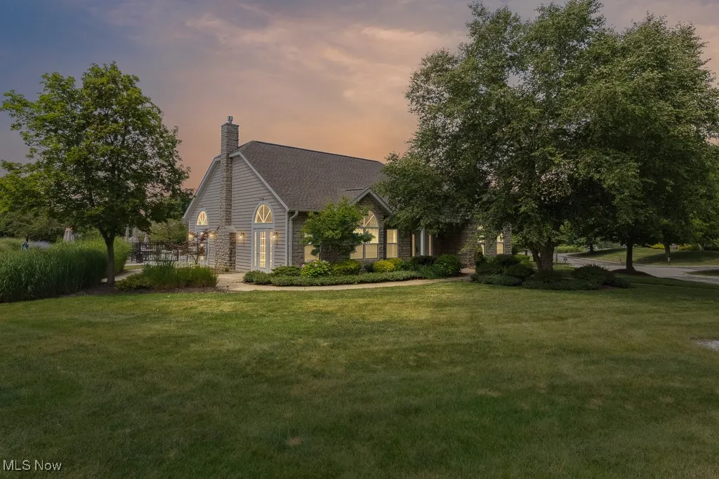 View of front facade featuring a front yard and a chimney