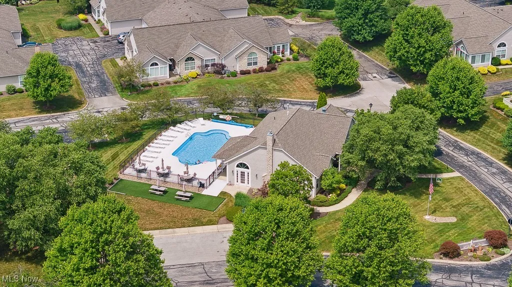 Aerial view of property and surrounding area with a pool