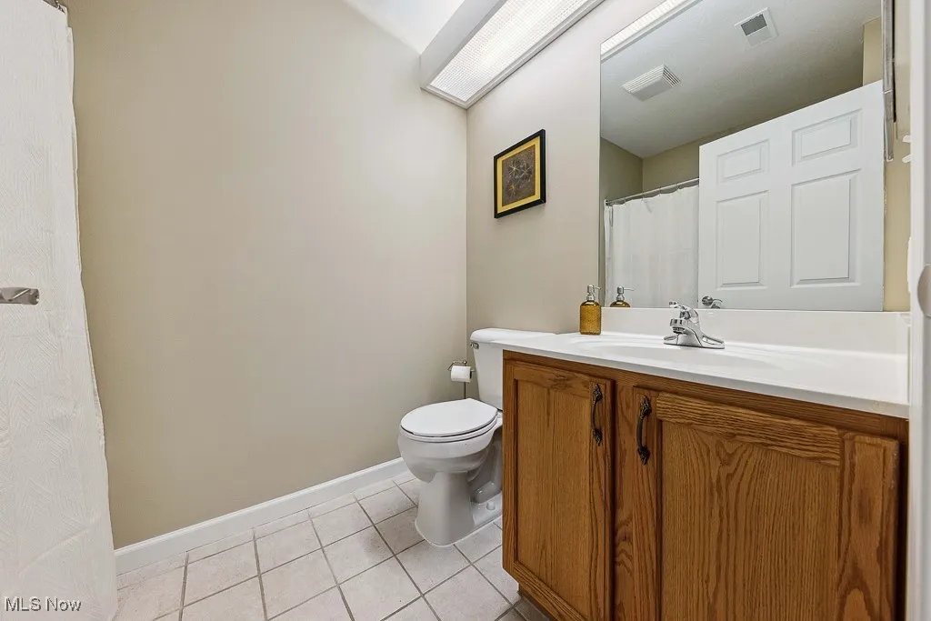 Full bathroom featuring tile patterned flooring and vanity