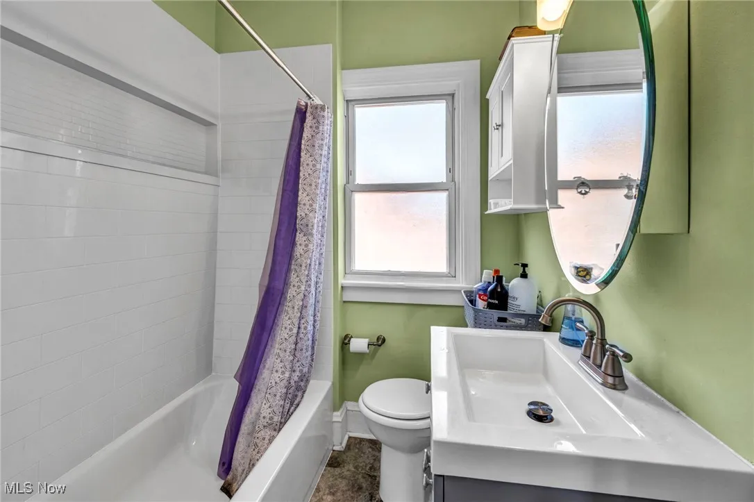 Bathroom with vanity and shower / tub combo