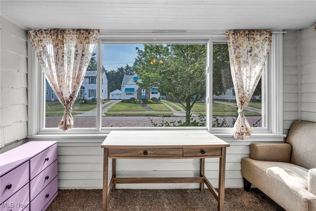 Sitting room with healthy amount of natural light and carpet floors
