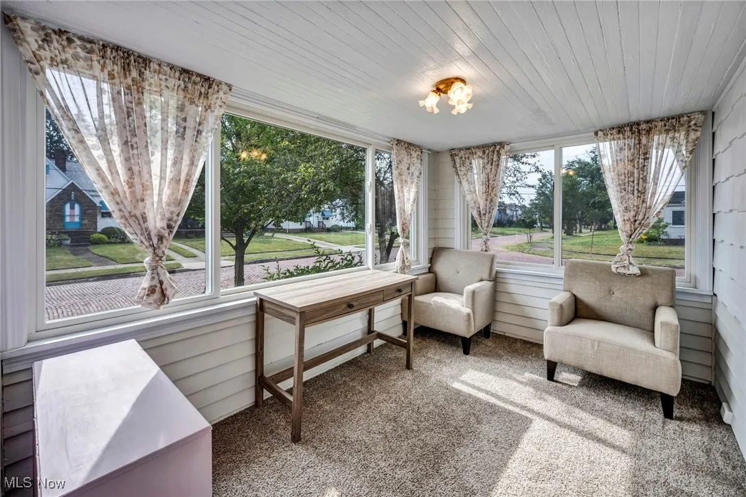 Sunroom / solarium with carpet floors and wood ceiling