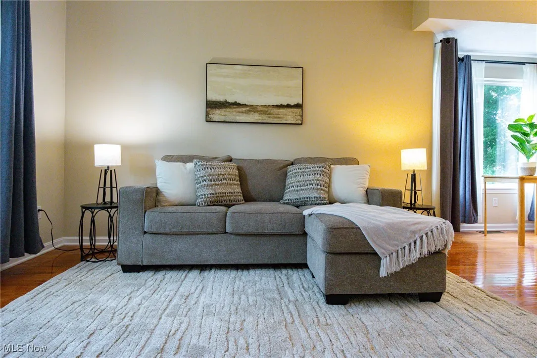 Living area with wood finished floors and baseboards