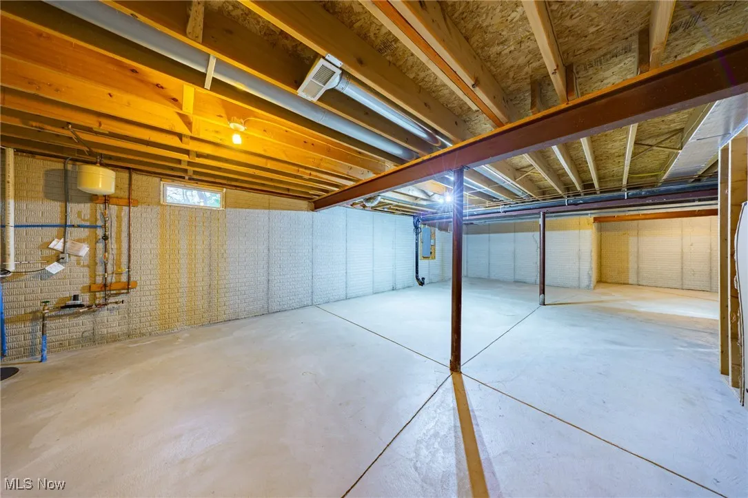 Unfinished basement with brick wall