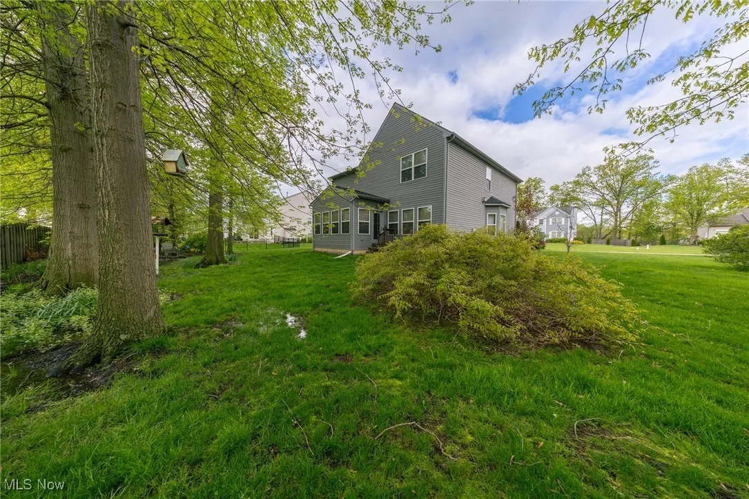 Back of property with a yard