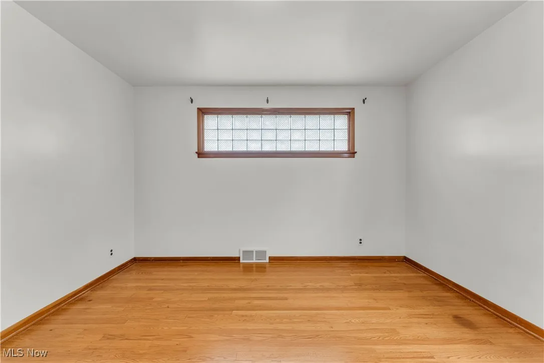 Spare room with light wood-style floors and baseboards