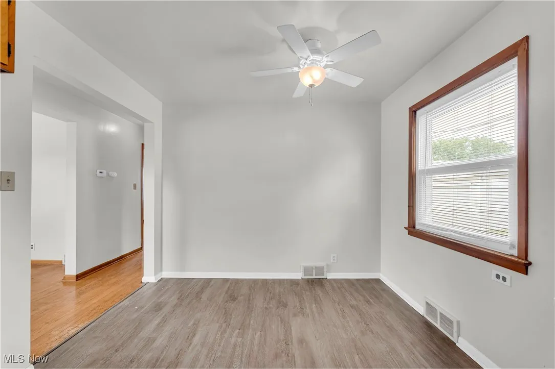 Unfurnished room featuring wood finished floors and ceiling fan