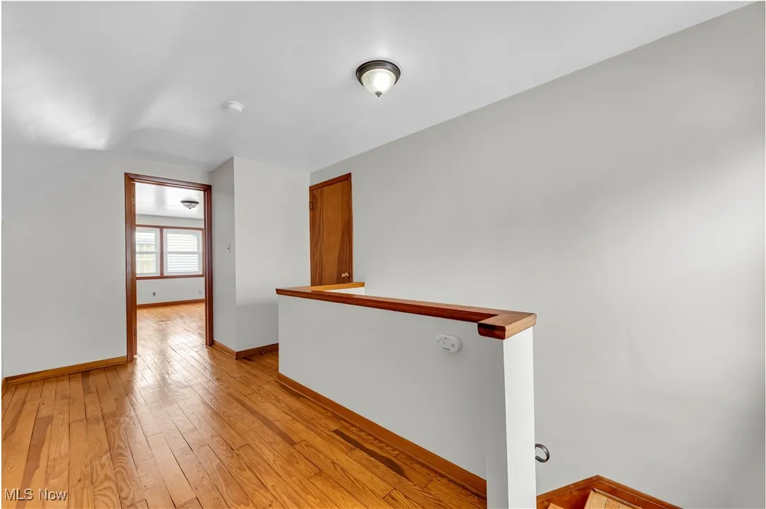 Empty room with baseboards and light wood-style floors
