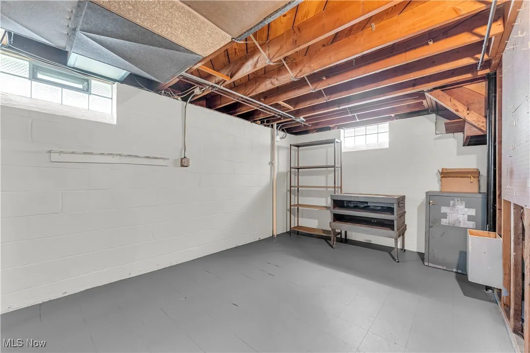 Below grade area featuring tile patterned floors and concrete block wall