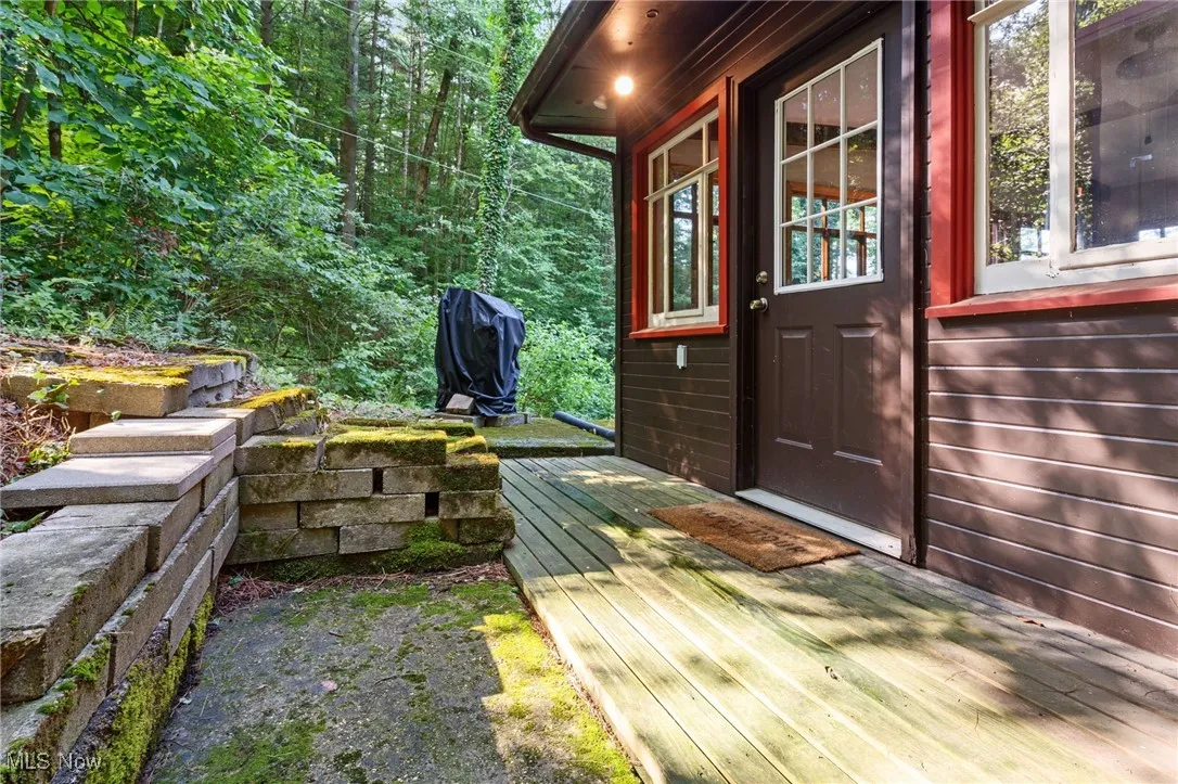 View of exterior entry with a wooden deck