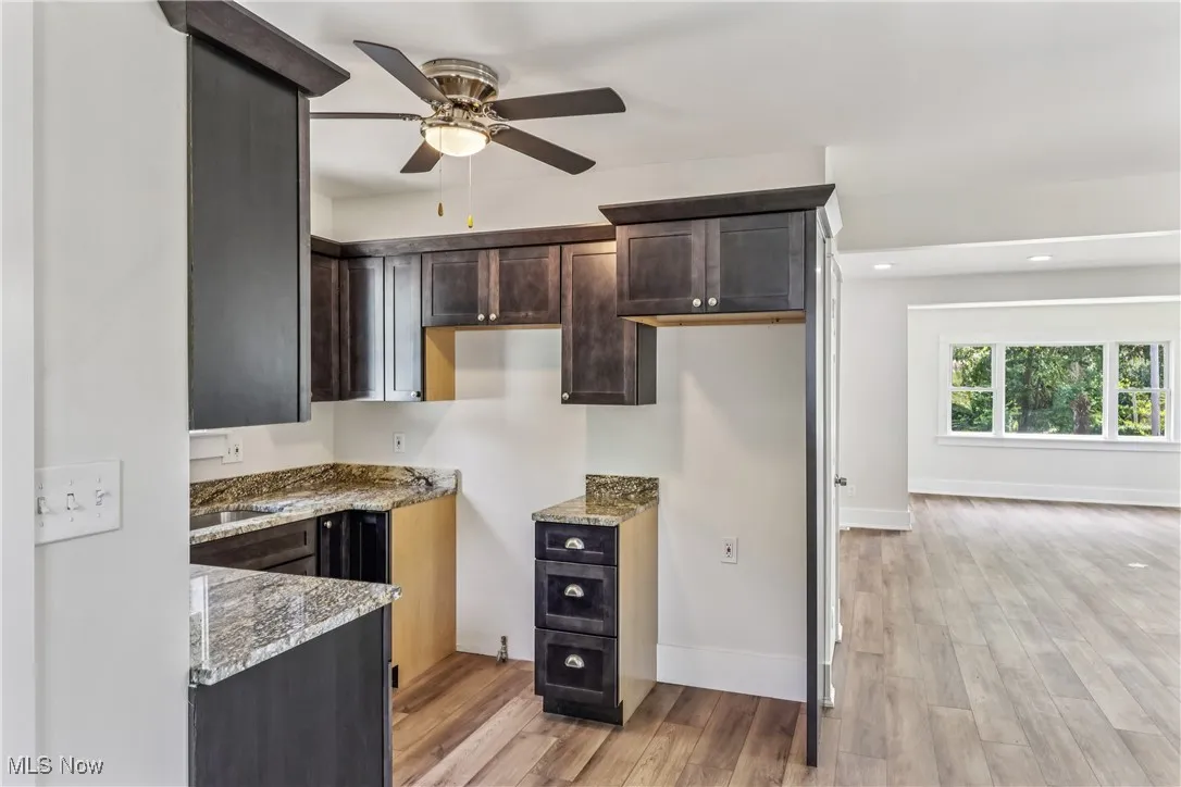 Kitchen with a sink, ceiling fan / light with LVT flooring