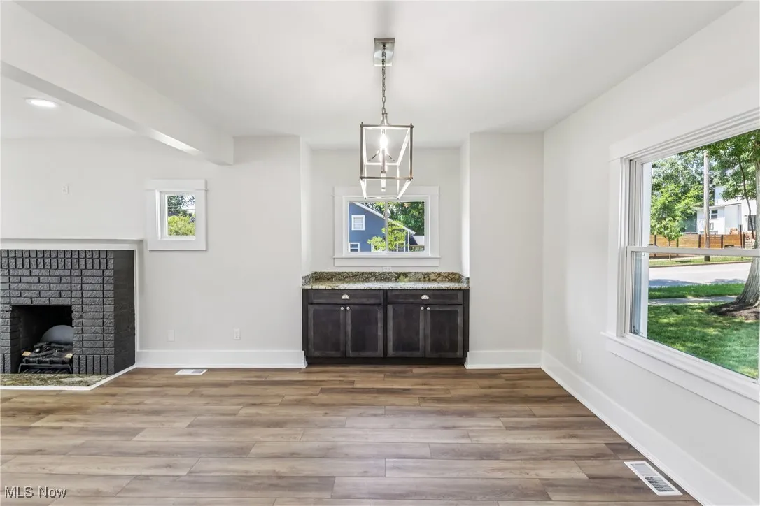 Dining room with built-in cabinet, chandelier and LVT flooring