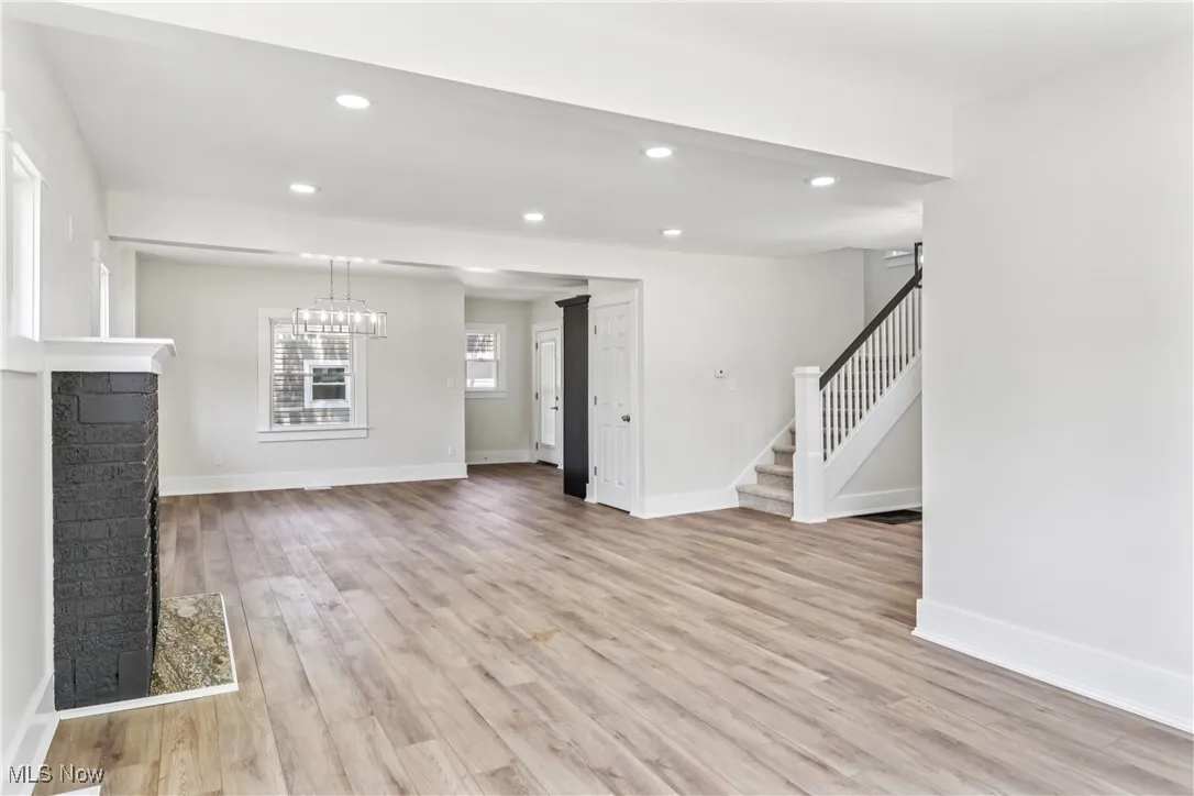 Living room looking into dining room with chandelier