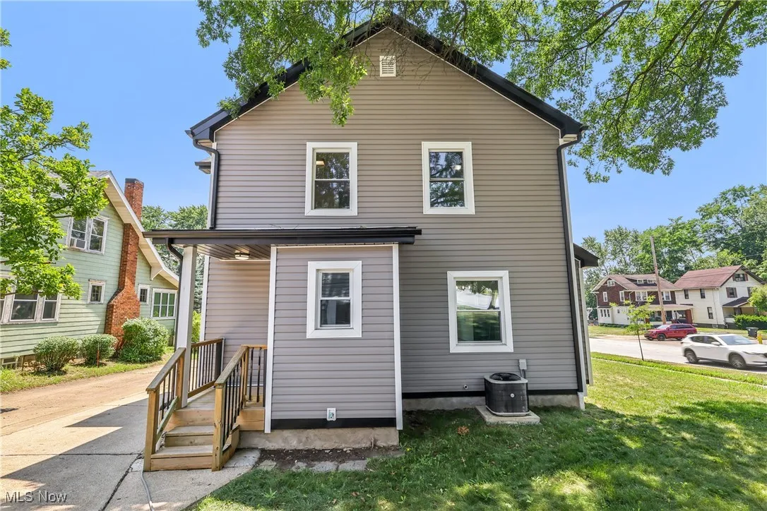 Rear view of house featuring a yard