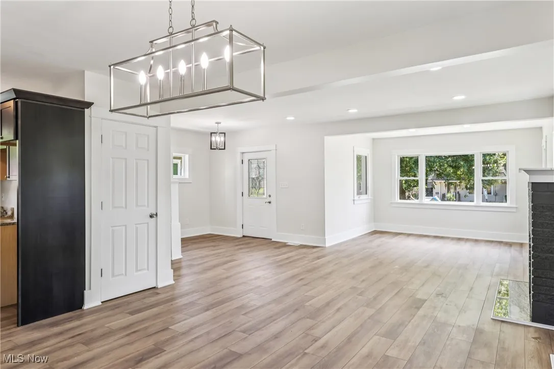 Dining room looking into living room with a chandelier and LVT flooring