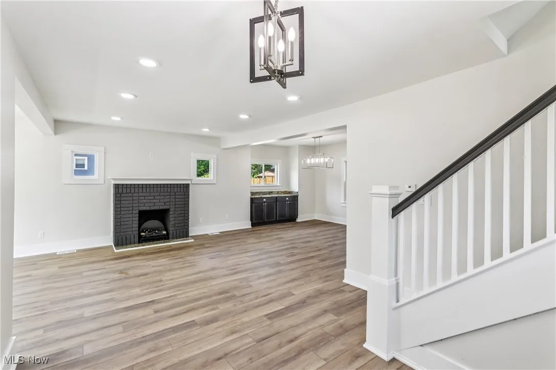 Living room with electric fireplace, recessed lighting and LVT flooring