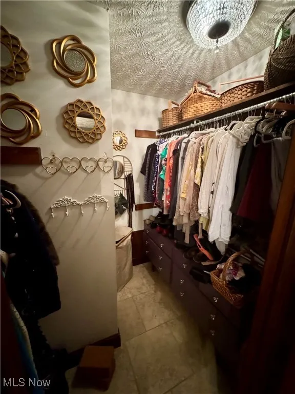 Walk in closet featuring tile patterned flooring