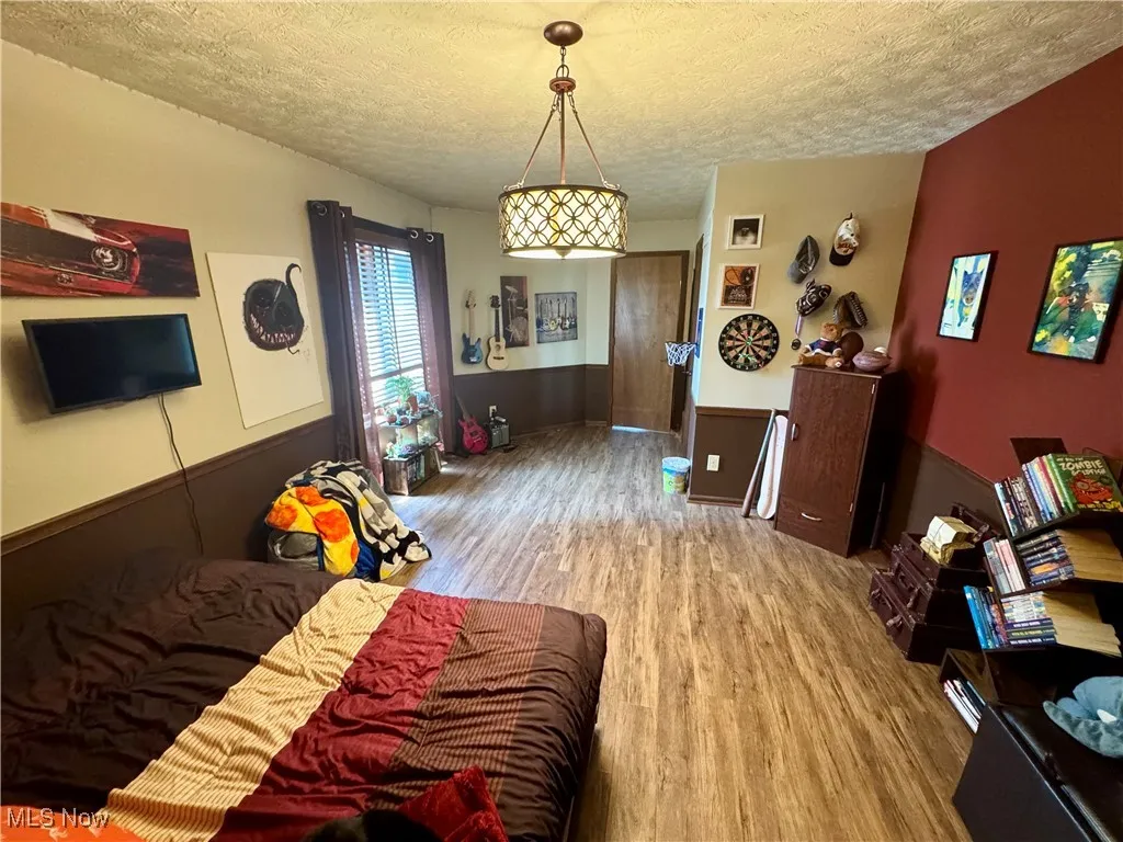 Living area with wood finished floors and a textured ceiling