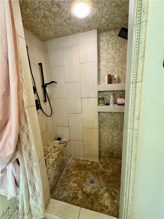 Bathroom featuring tiled shower