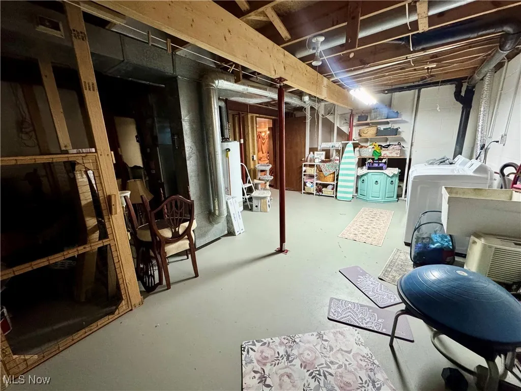 Unfinished basement with washer and clothes dryer