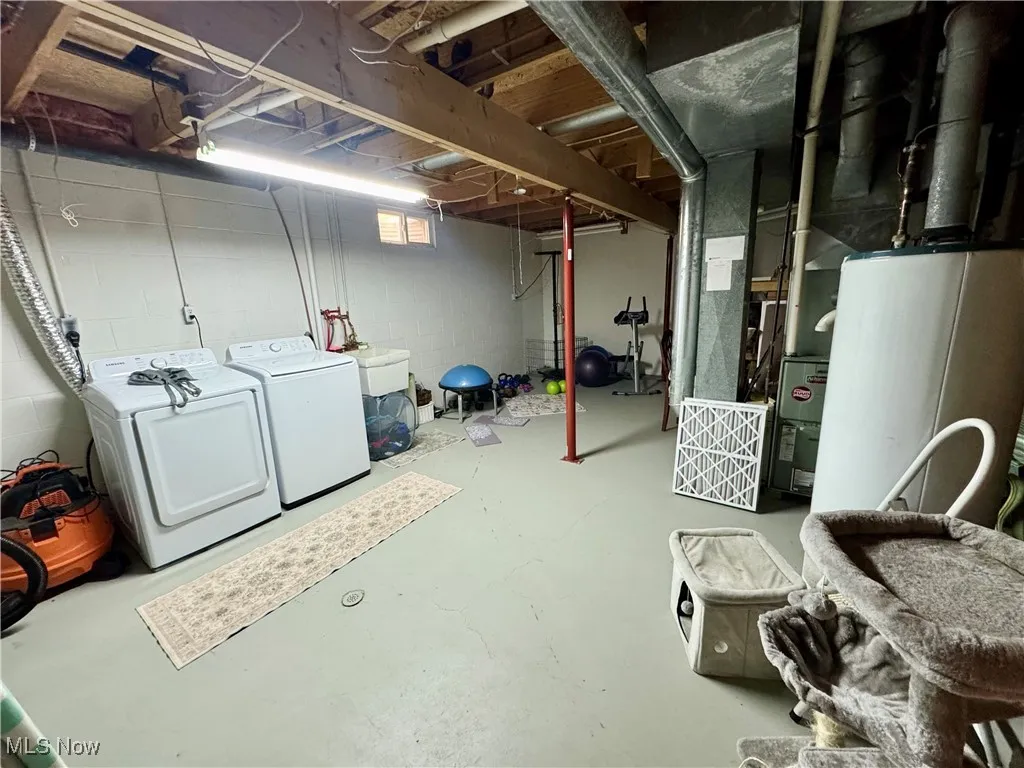 Basement with washing machine and dryer and water heater