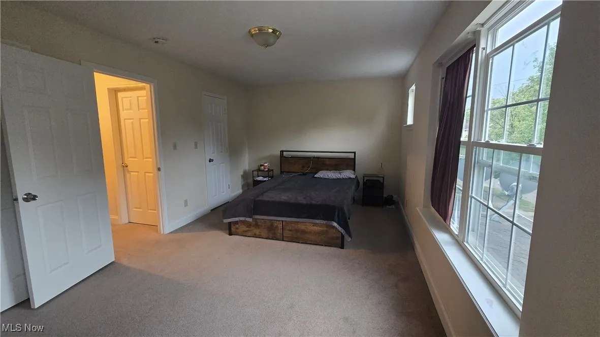 Bedroom with carpet floors and baseboards