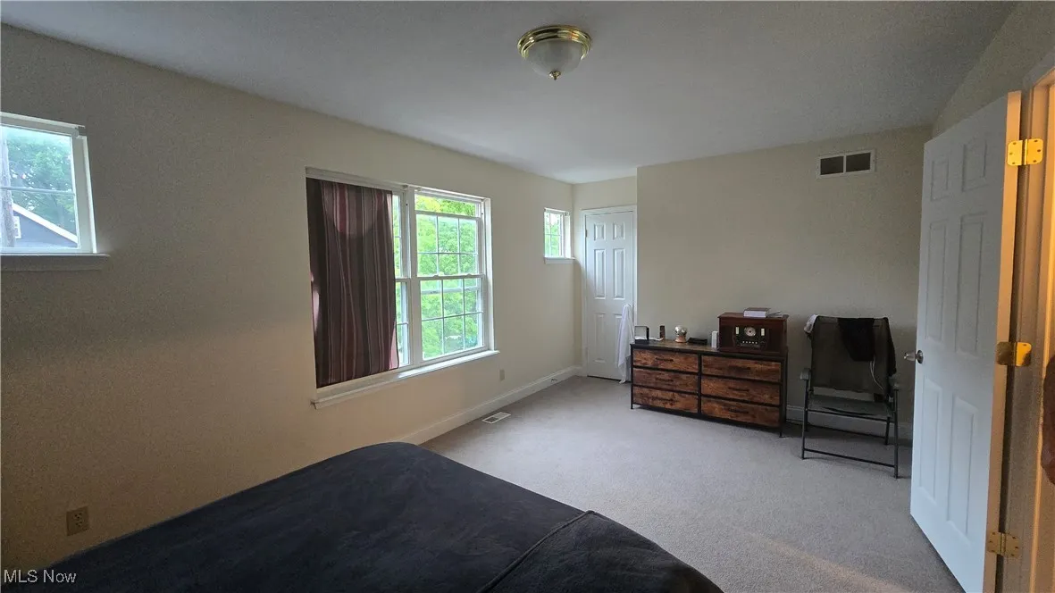 Bedroom featuring carpet flooring and baseboards