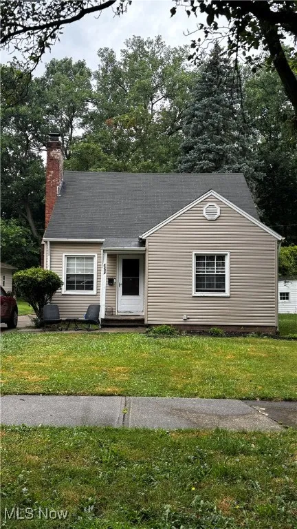 View of front of house with a front lawn and a chimney