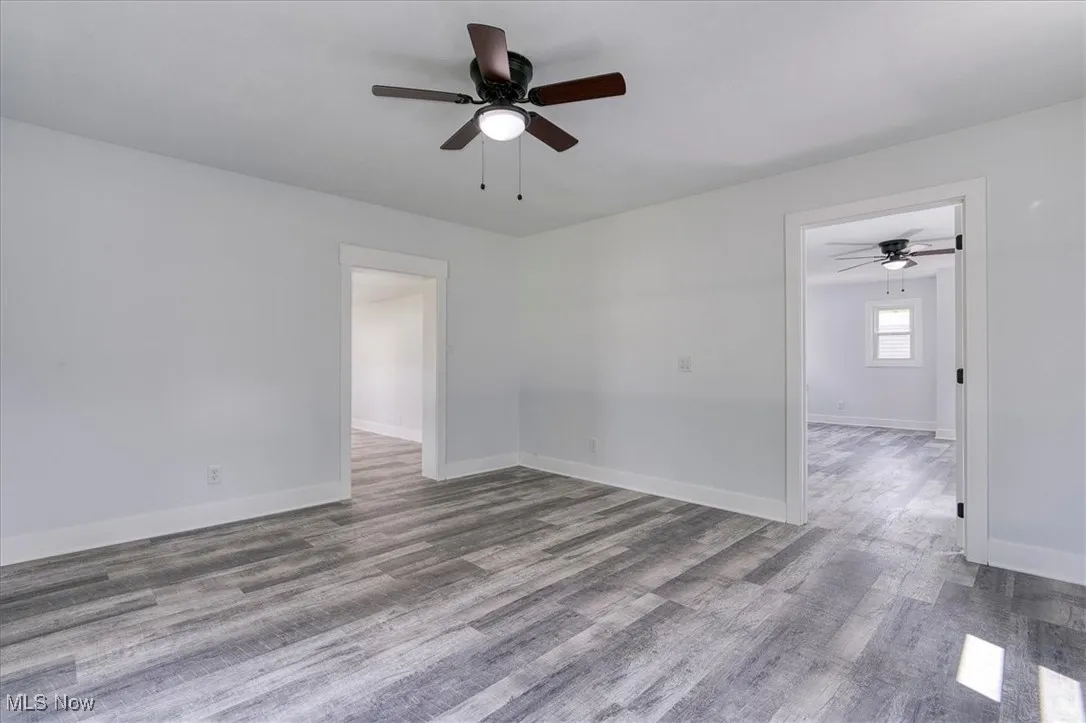 Spare room featuring a ceiling fan and wood finished floors