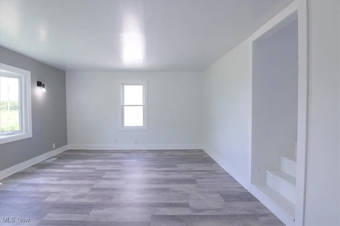 Empty room featuring wood finished floors and baseboards