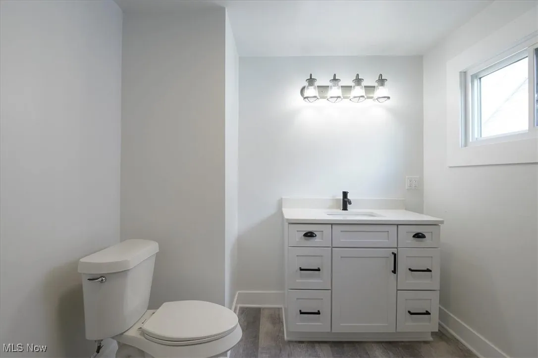 Bathroom with vanity and wood finished floors