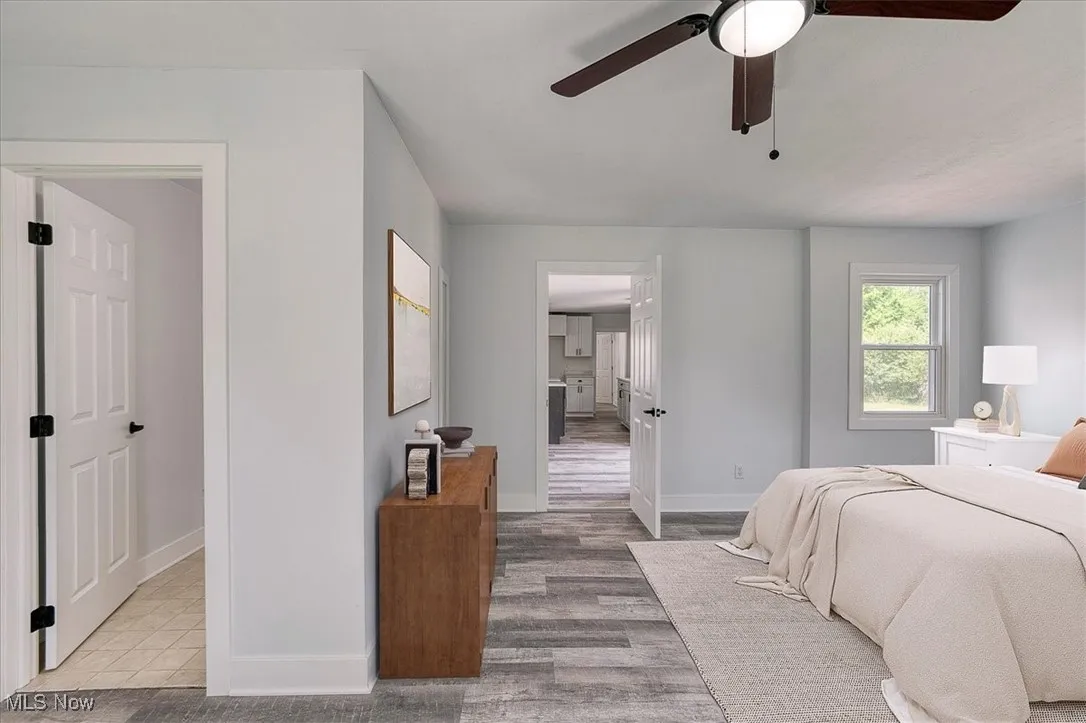 Bedroom with wood finished floors and ceiling fan