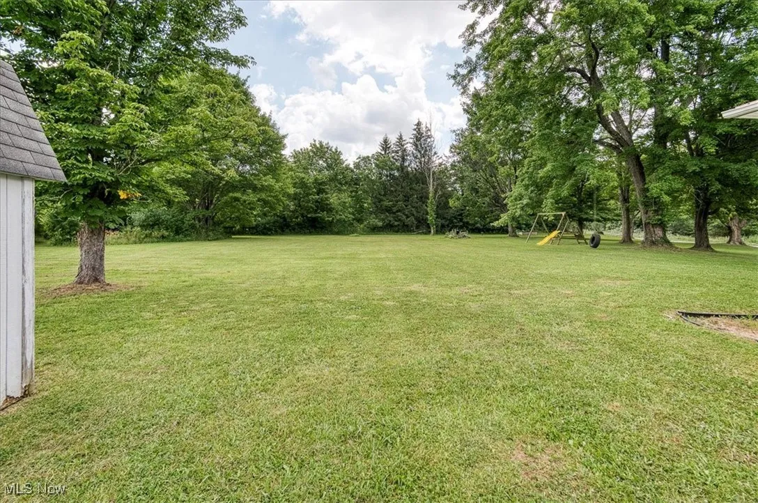 View of grassy yard with a playground