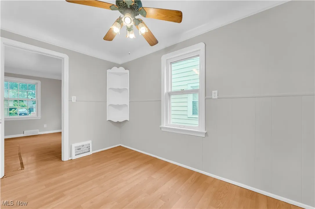 Unfurnished room featuring wood finished floors and ceiling fan