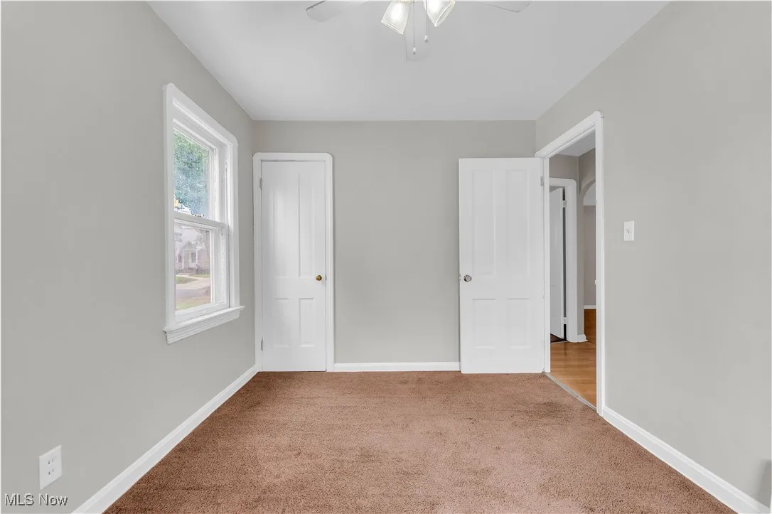 Unfurnished bedroom with carpet flooring and ceiling fan