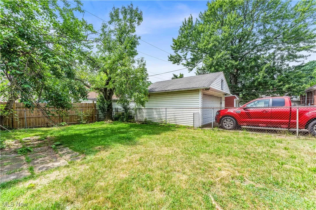 View of yard with an outbuilding and a garage