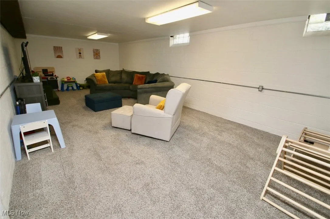 Living area with concrete block wall and carpet