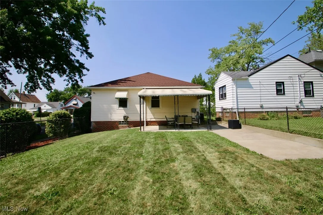 Rear view of house with a patio area and a fenced backyard