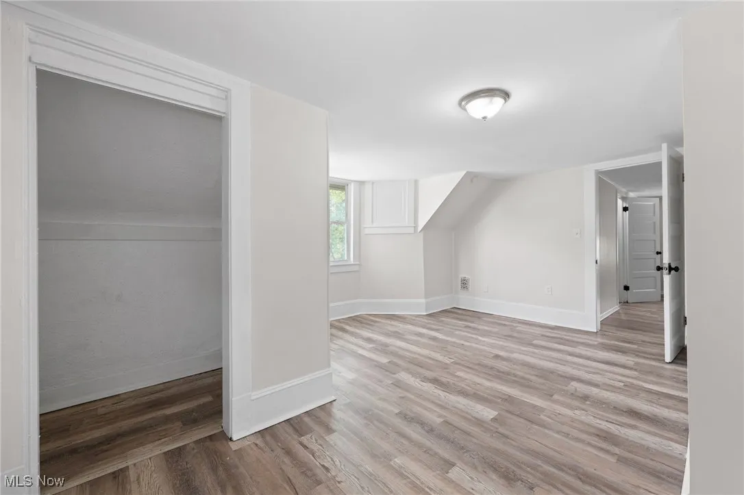 Bedroom with wood style floors and baseboards