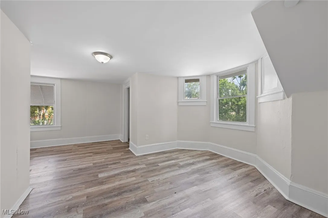 Bedroom with lots of natural light and wood style floors