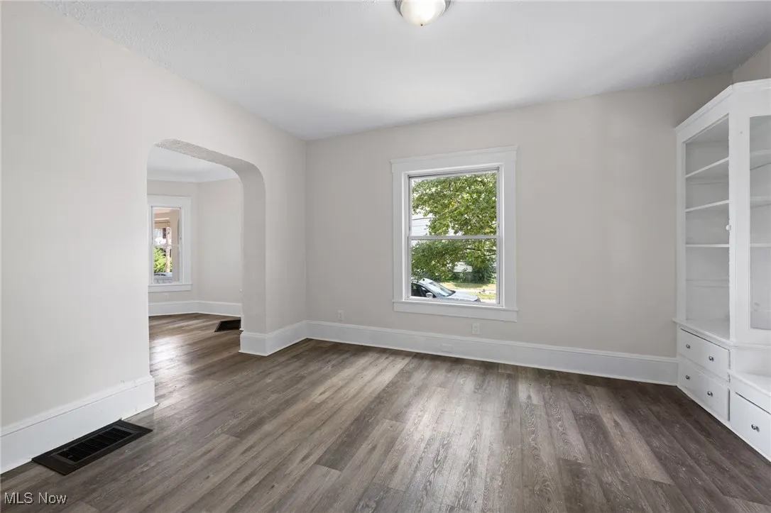 Dining room with plenty of natural light, wood style  floors, and arched walkways