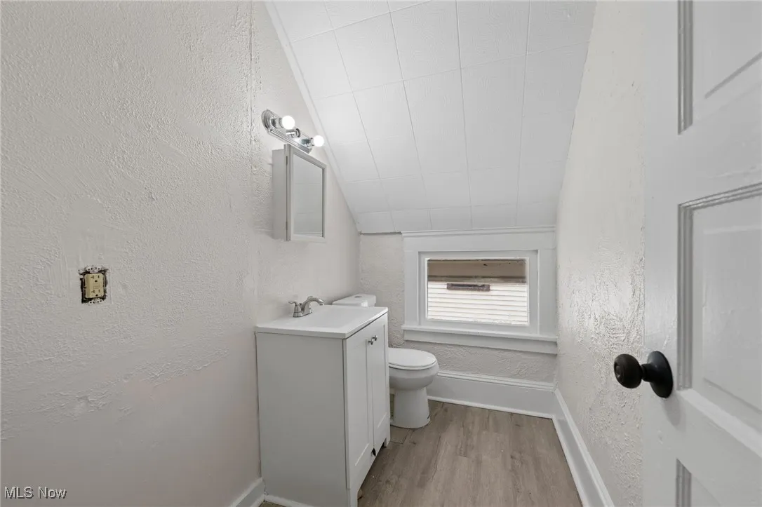 Bathroom featuring vanity, and wood style floors