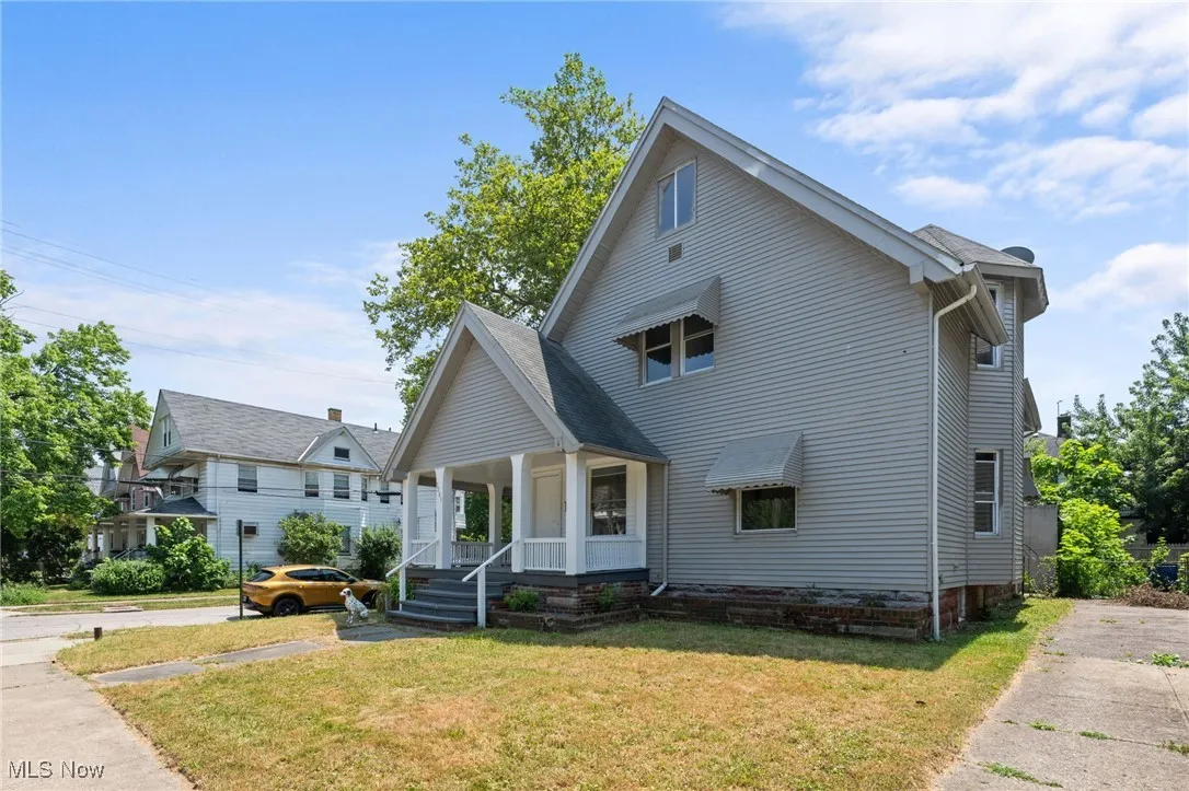 View of front of home with a porch and a front lawn
