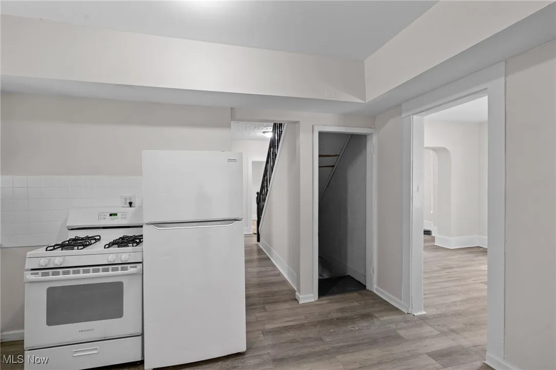 Kitchen with white appliances and light wood-type flooring